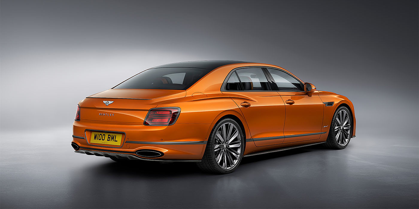 Bentley Kuala Lumpur Bentley Flying Spur Speed in Orange Flame colour rear view, featuring Bentley insignia and enhanced exhaust muffler.