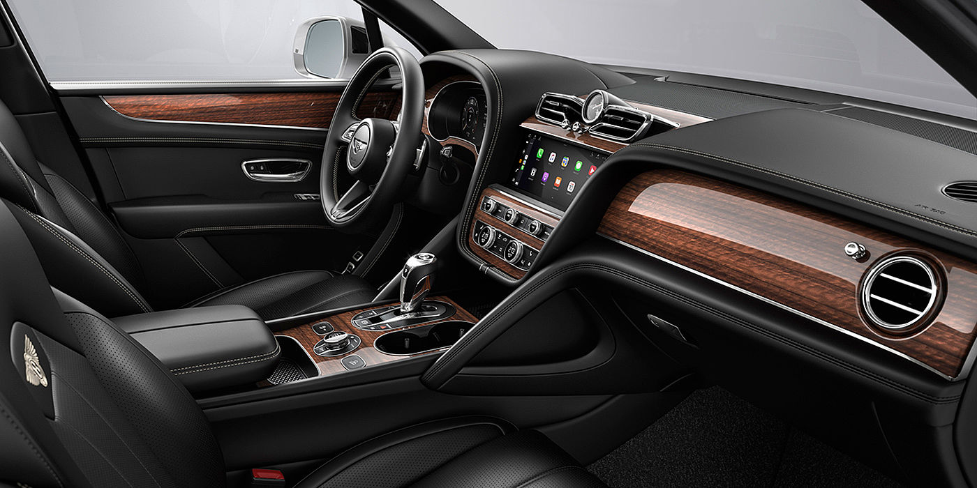 Bentley Kuala Lumpur Bentley Bentayga interior with a Crown Cut Walnut veneer, view from the passenger seat over looking the driver's seat.