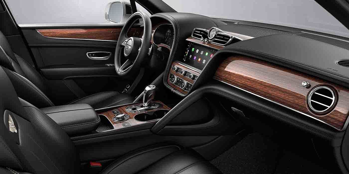 Bentley Kuala Lumpur Bentley Bentayga EWB interior with a Crown Cut Walnut veneer, view from the passenger seat over looking the driver's seat.
