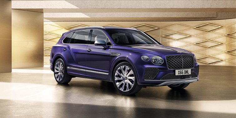 Bentley Kuala Lumpur Bentley Bentayga Extended Wheelbase Mulliner SUV front three quarter in Tanzanite Purple paint with a gold patterned background