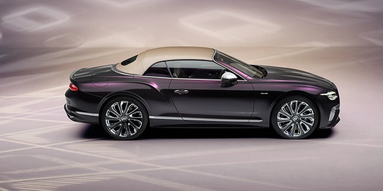 Bentley Kuala Lumpur Bentley Continental GTC Mulliner convertible in profile with hood up, in Tanzanite Purple paint and 22 inch Mulliner painted and polished wheels