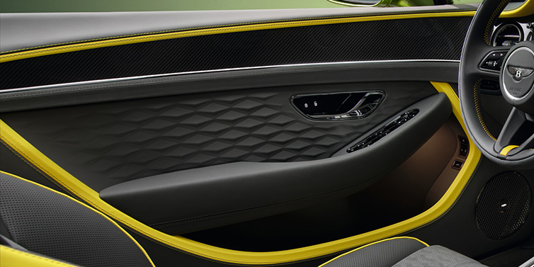 Bentley Kuala Lumpur Bentley Continental GTC Speed convertible interior door details featuring Gravity Grey and Cyber Yellow by Mulliner hides and high gloss carbon fibre veneer