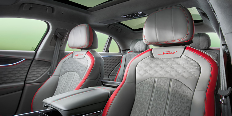 Bentley Kuala Lumpur Bentley Flying Spur Speed sedan interior showing front and rear seats in Hotspur red and Gravity Grey hides, with Speed seat emblems