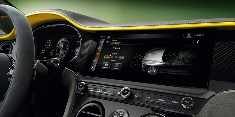 Bentley Kuala Lumpur Bentley Continental GTC Speed convertible front interior centre console with MMI screen showing Air Quality visualisation surrounded by Cyber Yellow by Mulliner and Gravity Grey hides and high gloss carbon fibre veneer