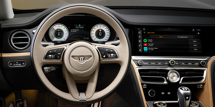 Bentley Kuala Lumpur Bentley Flying Spur Mulliner sedan front interior detail of steering wheel and driver screens surrounded by Linen and Beluga black hides