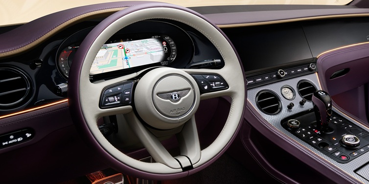 Bentley Kuala Lumpur Bentley Continental GT Mulliner coupe front interior showing steering wheel and drivers screens surrounded by Linen and Damson hides and Grand Black veneer